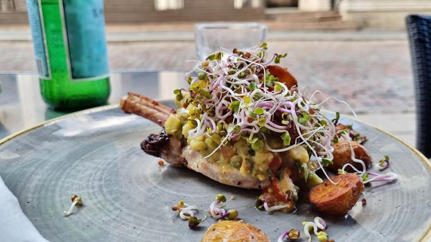 Grilled beef steaks and germinated sprouts on a plate.