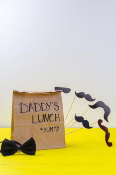 Vertical shot of paper bag and copy space. Lunch for loving daddy.