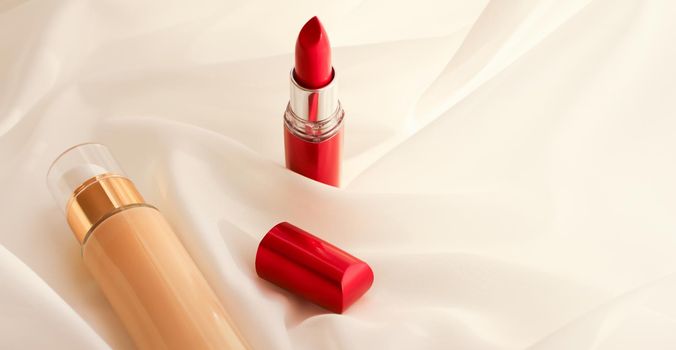 Cosmetic branding, glamour and skincare concept - Beige tonal cream bottle make-up fluid foundation base and red lipstick on silk background, cosmetics products as luxury beauty brand holiday design