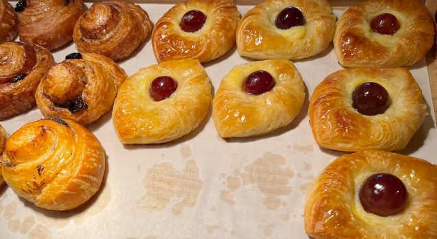 freshly baked danish pastry with apricot jam fruity jelly super delicious warm fresh buttery baked pastries with apricot and peach in bakery kitchen