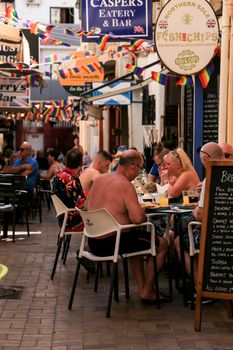 Benidorm, Alicante, Spain- September 10, 2022: Bars and terraces of typical spanish food full of people in the old town of Benidorm