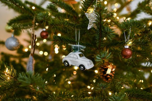 White car and toys hanging on a Christmas tree
