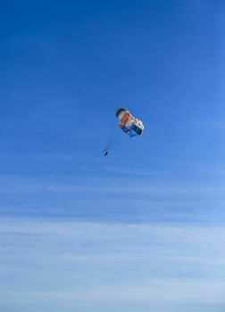 Benidorm, Alicante, Spain- September 11, 2022: People parasailing in Santa Pola on a sunny day of summer
