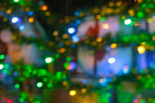 Blurred background, bright Christmas lights of the New Year tree, background