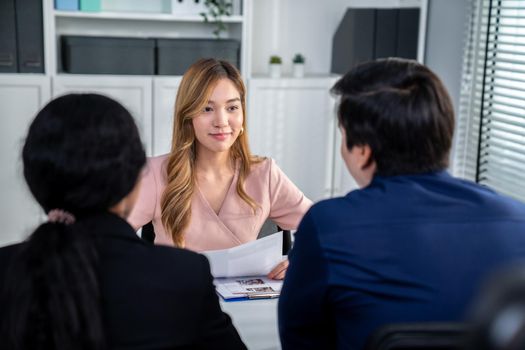 A young female asian candidate tries to impress her interviewer by being competent. International company, multicultural environment in workplace.