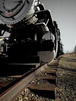 Old steam locomotive stretches down the tracks.