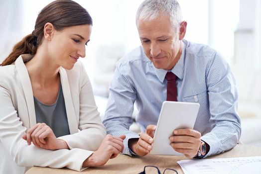 Technology helping meetings run smoothly. two colleagues using a digital tablet in the office