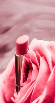 Cosmetic branding, luxe and fashion concept - Pink lipstick and rose flower on liquid background, waterproof glamour make-up and lip gloss cosmetics product for luxury beauty brand holiday design