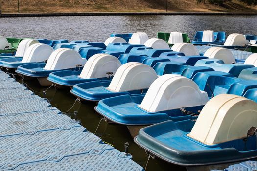 Catamarans parked at the pier on river close up