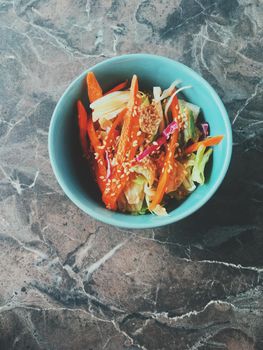 Vegan dieting, eating out and oriental cuisine concept - Vegetarian asian vegetable salad served in a bowl in japanese restaurant, healthy diet food