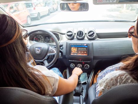 Beautiful business lady driving her car a cloudy day in summertime