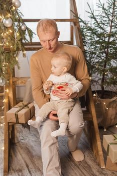 Dad and his little son in a magical Christmas atmosphere. The concept of family relations and New Year celebrations