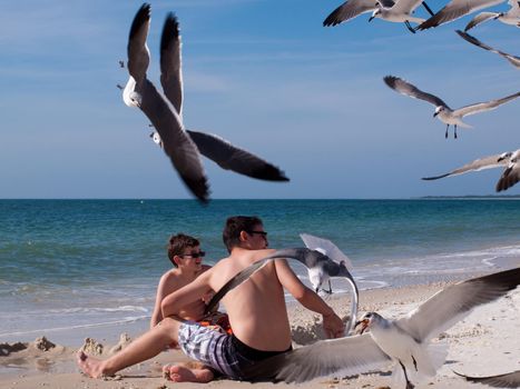 Brothers playing in sand on the Mexico Beach, Florida.