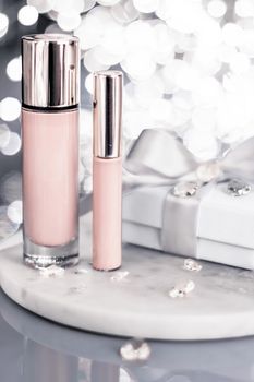 Cosmetic branding, Christmas glitter and girly blog concept - Holiday make-up foundation base, concealer and white gift box, luxury cosmetics present and blank label products for beauty brand design