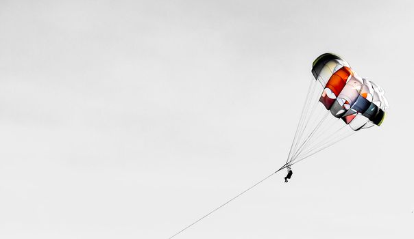 Benidorm, Alicante, Spain- September 11, 2022: People parasailing in Santa Pola on a sunny day of summer