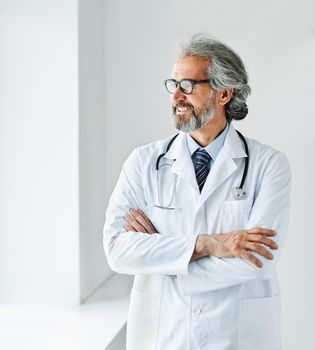 portrait of a senior doctor in his office in a hospital