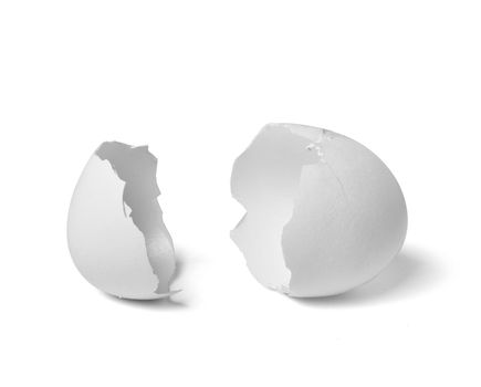 Close up of a broken white eggshell on white background