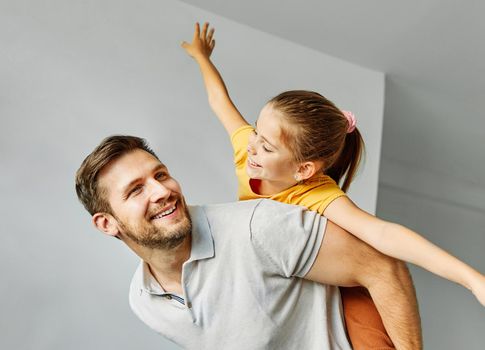 Family father and daughter having fun playing at home