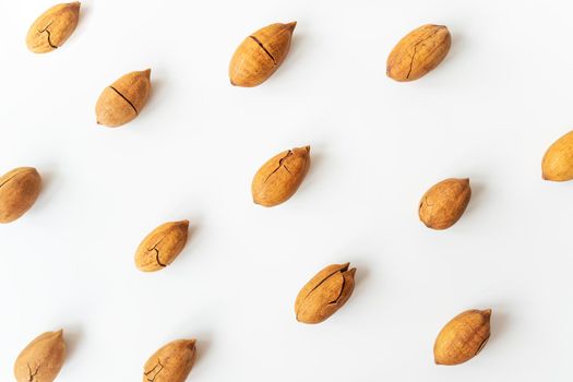 Shelled pecan on a white table. Healthy nuts, vegetarianism. Selective focus