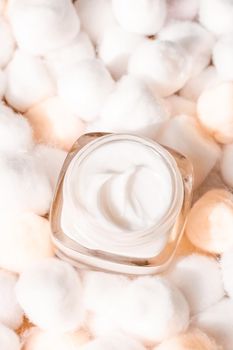 Cosmetic branding, moisturizing emulsion and facial care concept - Luxury face cream for sensitive skin and orange cotton balls on background, spa cosmetics and natural skincare beauty brand product