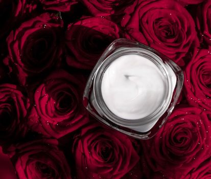 Luxe cosmetics, branding and anti-age concept - Face cream skin moisturizer and red roses flowers, luxury skincare cosmetic product on floral background as beauty brand holiday flatlay design