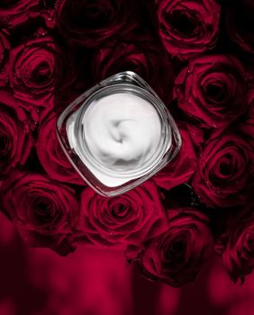 Luxe cosmetics, branding and anti-age concept - Face cream skin moisturizer and red roses flowers, luxury skincare cosmetic product on floral background as beauty brand holiday flatlay design