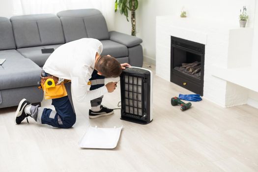 air purifier repairman turning a filter into a new one.