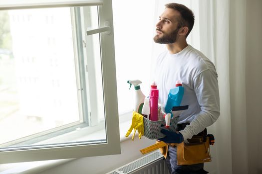 House cleaning. Washing dirty window glass detergent in winter