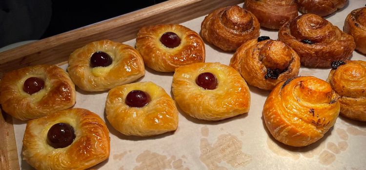 freshly baked danish pastry with apricot jam fruity jelly super delicious warm fresh buttery baked pastries with apricot and peach from baker's kitchen