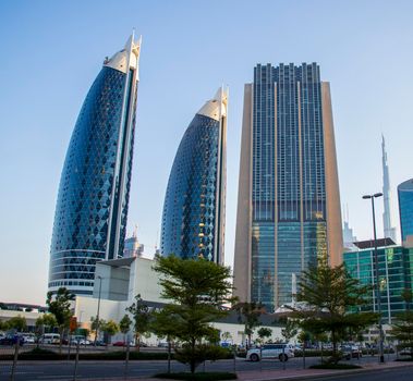 Dubai Financial Center road. Landmarks such Burj Khalifa, tallest building in the world, Index tower, Park towers can be seen on the scene. Outdoors