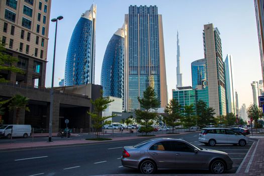 Dubai Financial Center road. Landmarks such Burj Khalifa, tallest building in the world, Index tower, Park towers and Address Sky view can be seen on the scene. Outdoors