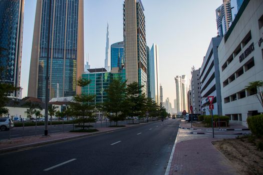 Dubai Financial Center road. Landmarks such Burj Khalifa, tallest building in the world, Index tower and Address Sky view can be seen on the scene. Outdoors