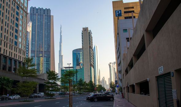 Dubai Financial Center road. Landmarks such Burj Khalifa, tallest building in the world, Index tower and Address Sky view can be seen on the scene. Outdoors