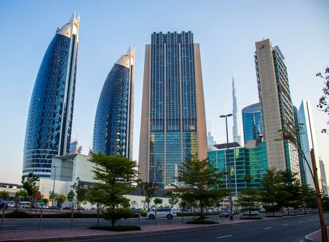 Dubai Financial Center road. Landmarks such Burj Khalifa, tallest building in the world, Index tower, Park towers can be seen on the scene. Outdoors