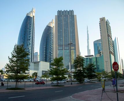 Dubai Financial Center road. Landmarks such Burj Khalifa, tallest building in the world, Index tower, Park towers and Address Sky view can be seen on the scene. Outdoors