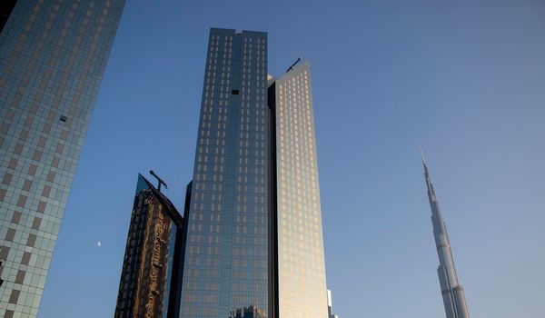 Towers in Dubai International Financial Center, Burj Khalifa, Tallest building in the world can be seen in the scene. Outdoors