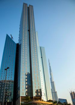 Towers in Dubai International Financial Center, Burj Khalifa, Tallest building in the world can be seen in the scene. Outdoors