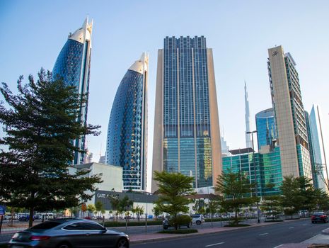 Dubai Financial Center road. Landmarks such Burj Khalifa, tallest building in the world, Index tower, Park towers can be seen on the scene. Outdoors
