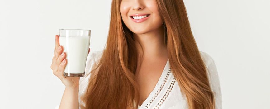 Diet, health and wellness concept, woman holding glass of milk or protein shake cocktail