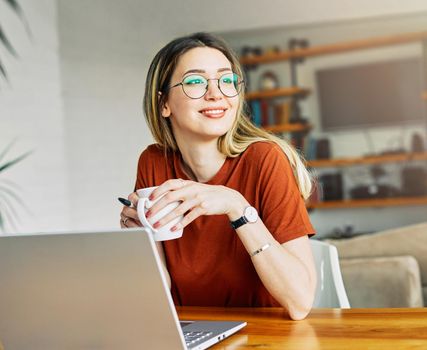 Portrait of a young girl using laptop at home