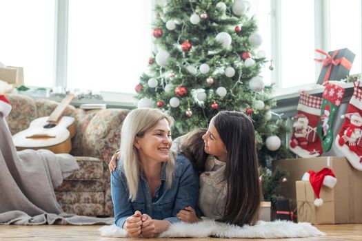 mother and daughter near the Christmas tree.