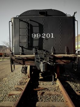 Vintage coal car on railroad tracks.
