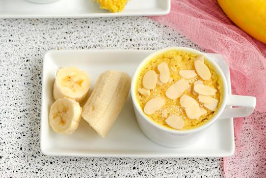 mini cake. Breakfast in a mug. selective focus. homemade Portioned Banana mugcake in small mugs. Easy sweet baking in the microwave idea, With fresh bananas, nuts. Muffin with banana slices cooked