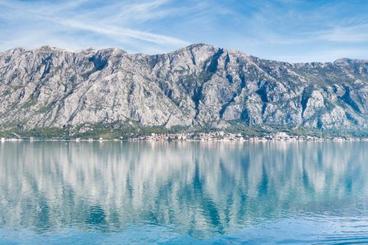 View of Bay of Kotor from the sea surrounded by mountains in Montenegro, one of the most beautiful bay in the world.