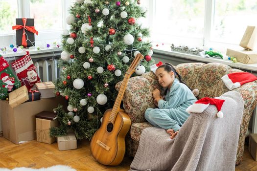 little girl near a christmas tree.