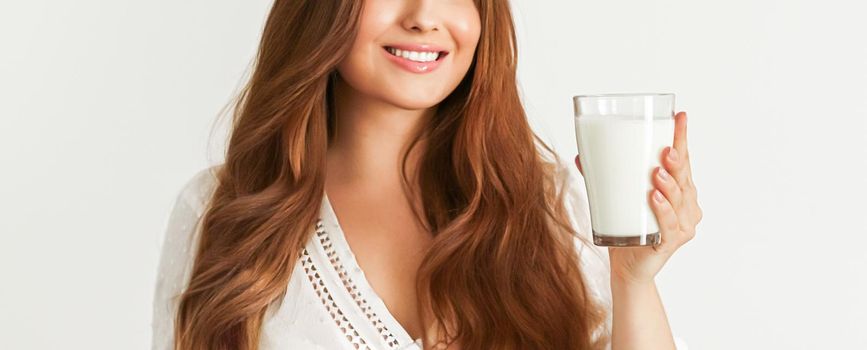 Diet, health and wellness concept, woman holding glass of milk or protein shake cocktail