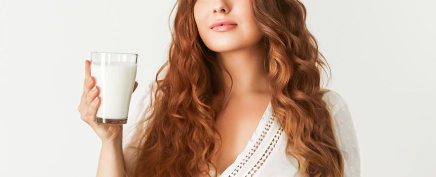 Diet, health and wellness concept, woman holding glass of milk or protein shake cocktail