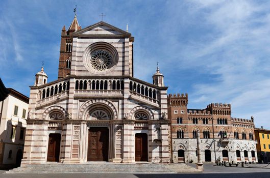Grosseto , Italy the cathedral of S. Lorenzo frontage decorated , in the background part of Piazza Dante the main square of the city  with Palazzo Aldobrandeschi seat of the provincial government