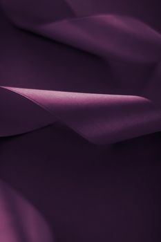 Branding, holidays and luxe brands concept - Abstract curly silk ribbon on purple background, exclusive luxury brand design for holiday sale product promotion and glamour art invitation card backdrop