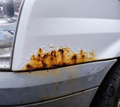 Surface Rust On The Bodywork Of A White Van Or Truck
